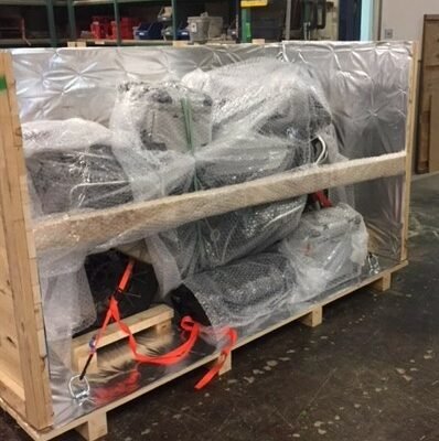 Motorbike parts bubble-wrapped inside a crate