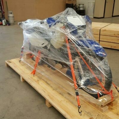 Motorbike fully wrapped in plastic film on a pallet