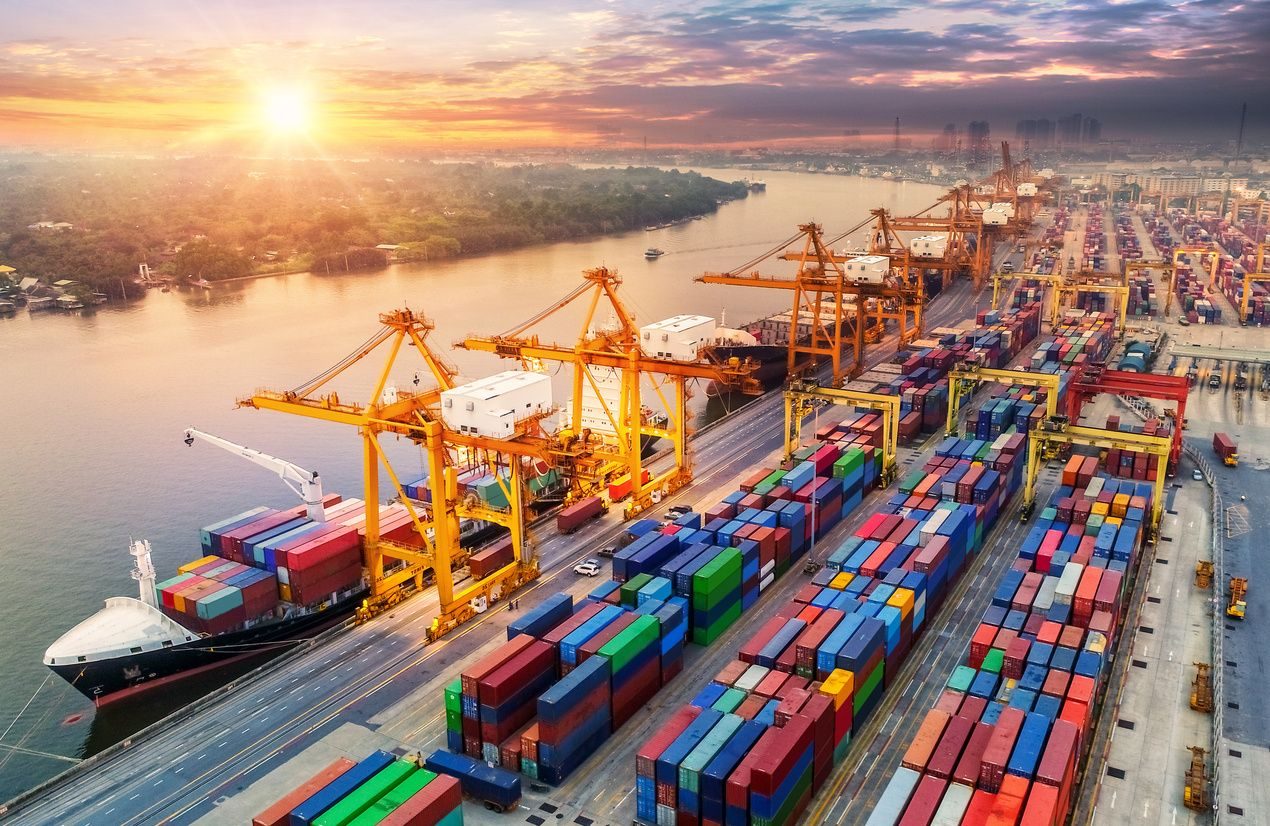 Aerial view of a port with cranes at sunrise
